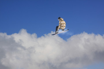 Snowboard rider jumping on mountains. Extreme snowboard freeride sport.