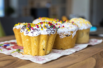 Traditional rustic style Orthodox sweet Easter bread (aka Paskha) topped with sugar glaze on a wooden board