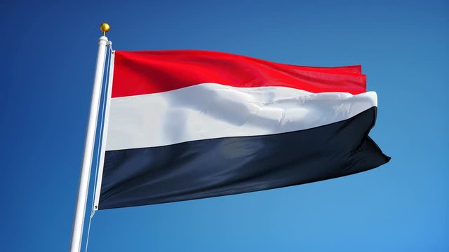 Yemen flag waving in slow motion against clean blue sky, seamlessly looped, close up, isolated on alpha channel with black and white luminance matte, perfect for film, news, digital composition