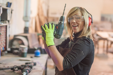 Female carpenter using power drill