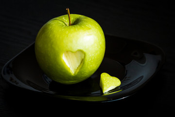 green apple with carved heart