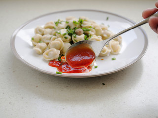 Meat dumplings on a plate with ketchup sauce,