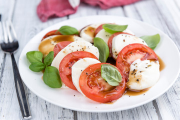 Portion of Mozarella with Tomatoes and Balsamico dressing