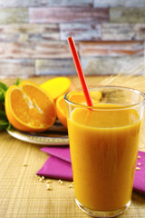 Healthy fresh pressed mango and orange juice with grains and min