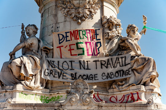 Paris, France - May 1, 2016: Banners against labour law on Statue Of the Republic of Place de la République. The french text means on top banner "Where are you democracy ?" 