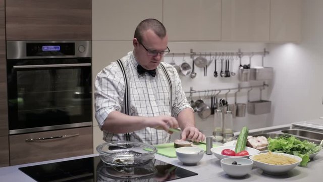 A man prepares fish steaks