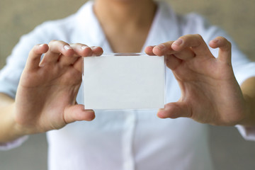 Businesswoman holding blank card 