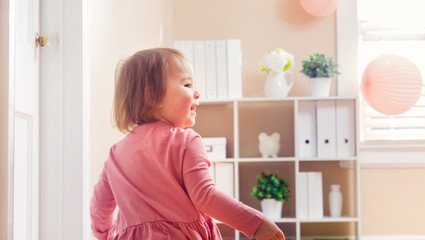 Happy toddler girl playing with toys