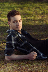 Leisure in park, man relaxing in park on grass