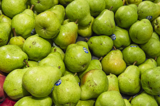 fresh green pears from market shelves real with flaws and bruise