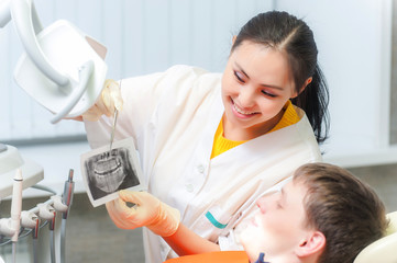 Dentist showing x-ray to a patient