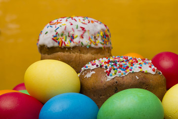 Easter eggs of different colors and cake