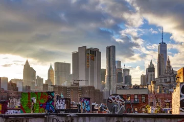 Zelfklevend Fotobehang Sunlight shines on lower Manhattan buildings at sunset in New York City © deberarr