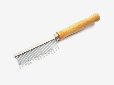 Wooden comb with metal prongs