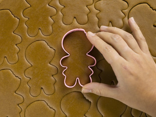 close-up shot of plastic cookie cutter on gingerbread dough.