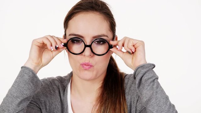 Woman in glasses smiling making silly face cross eyes 4K