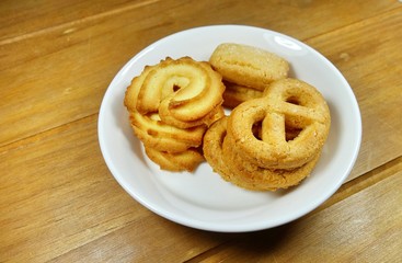 Butter cookies on a wood background.