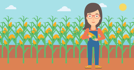 Farmer holding corn.