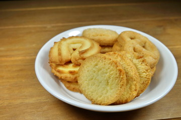 Butter cookies on a wood background.