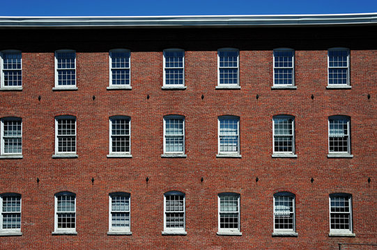 Old Red Brick Factory Building Exterior With Many Small Windows, Facade View