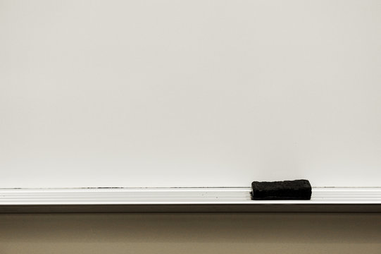 Close Up On White Board Eraser And Board In Classroom