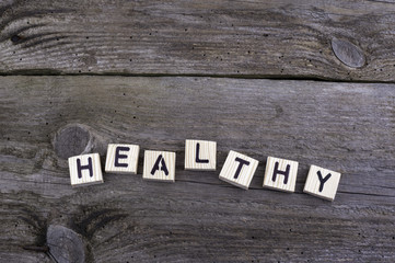 Text: Healthy from wooden letters on wooden background