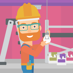 Electrician twisting light bulb.