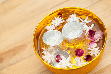 Water with jasmine and roses corolla in bowl for Songkran festival in Thailand.