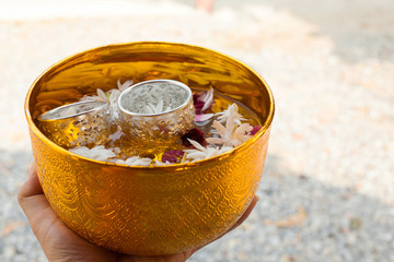 Water with jasmine and roses corolla in bowl for Songkran festival in Thailand.