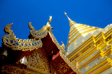 Fototapeta premium The famous gold temple Phrathat Doi Suthep with blue sky view
