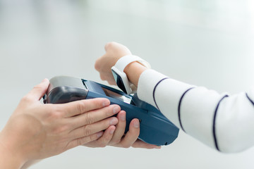 Female customer paying through smart watch