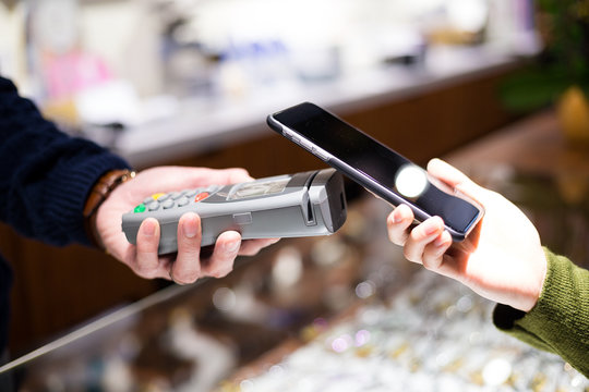 Woman using NFC technology to make payment