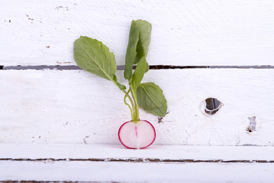 Fresh radishes on old wooden boards