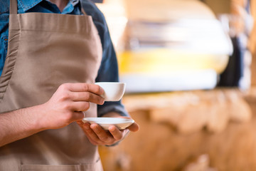 Pleasant waiter  working in the cafe