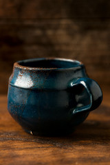 Coffee in grunge blue clay cup