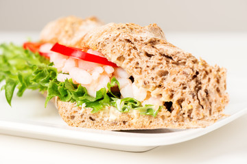 Prawn sandwich on white plate