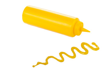 mustard bottle lying beside the mustard sauce