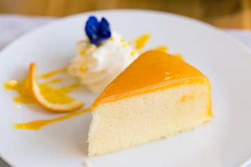 Orange cake on white plate. (Selected focus)
