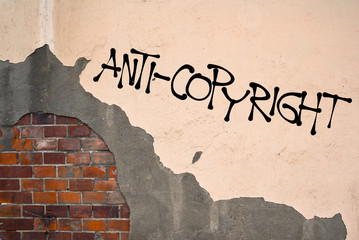 Handwritten graffiti Anti-Copyright sprayed on the wall, anarchist aesthetics. Appeal to...