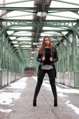 Obraz premium Beautiful girl in black leather jacket in winter time