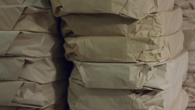 Big stack of packages. Thick paper packages. Huge order at company warehouse. Profitable wholesale trade.