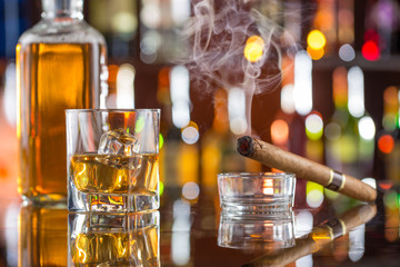 Whiskey drinks on bar counter.
