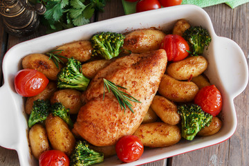 Chicken breast baked with tomato new potatoes and broccoli