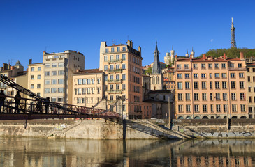 Fototapeta na wymiar Pedestrians on the Passerelle Saint-Vincent over the Saone river in Lyon city.