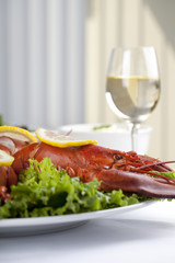 lobster in white plate with lemon slice