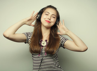 Fototapeta premium Young happy woman with headphones listening music 