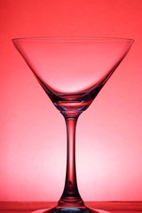 A cocktail glass over red background