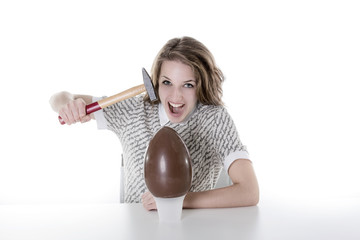 Young girl breaking an egg chocolate