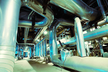 Equipment, cables and piping as found inside of a modern industr