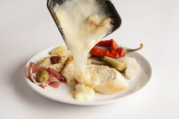 Raclette cheese melting on a plate